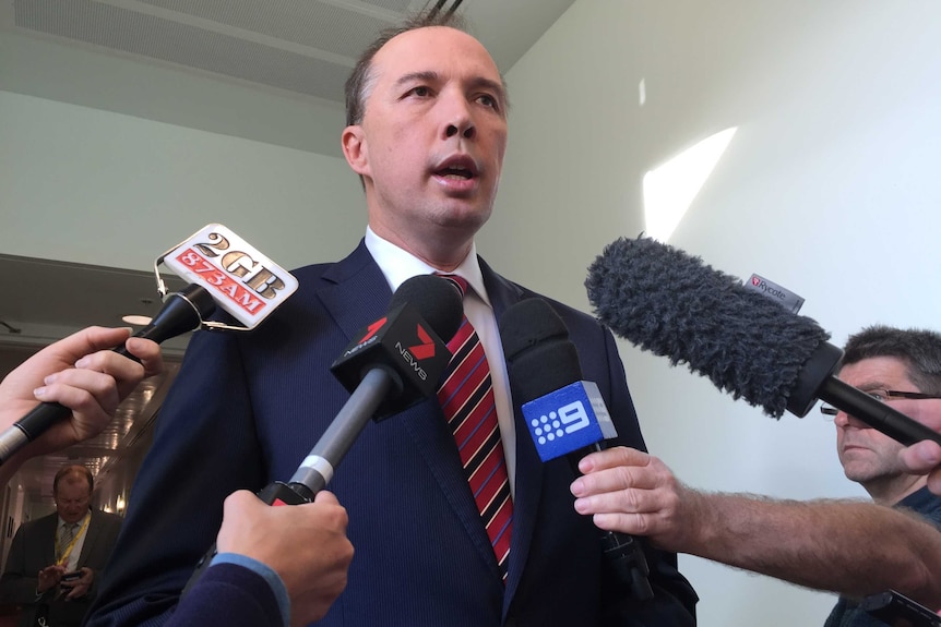 Immigration Minister Peter Dutton addresses a group of journalists during a doorstop in Parliament House, Canberra.