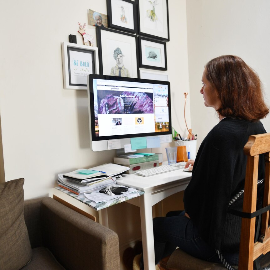 a woman sitting in front of a computer desk