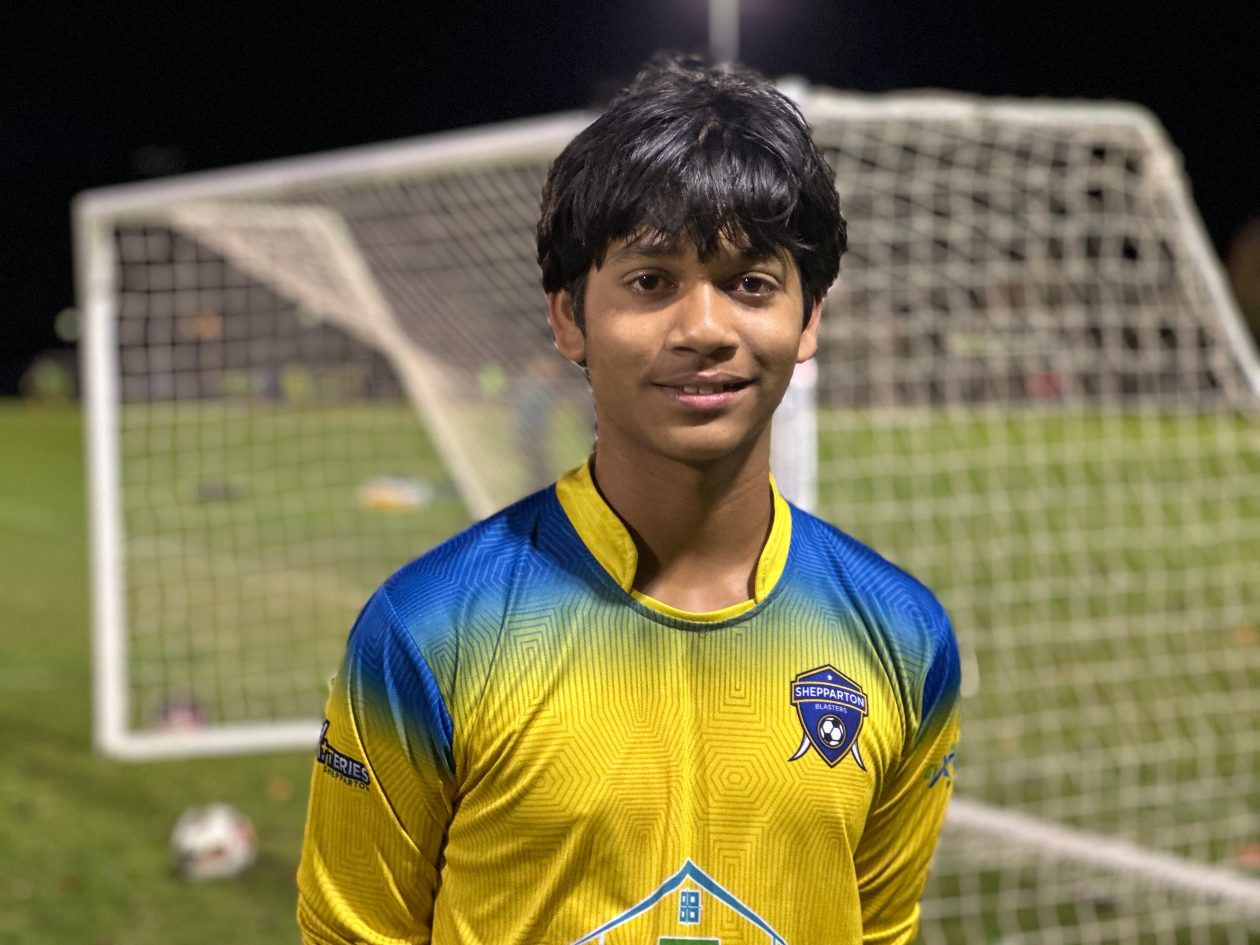 Close up of a young soccer player in front of a soccer goal