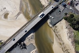 An aerial view of a major bridge crossing a river.