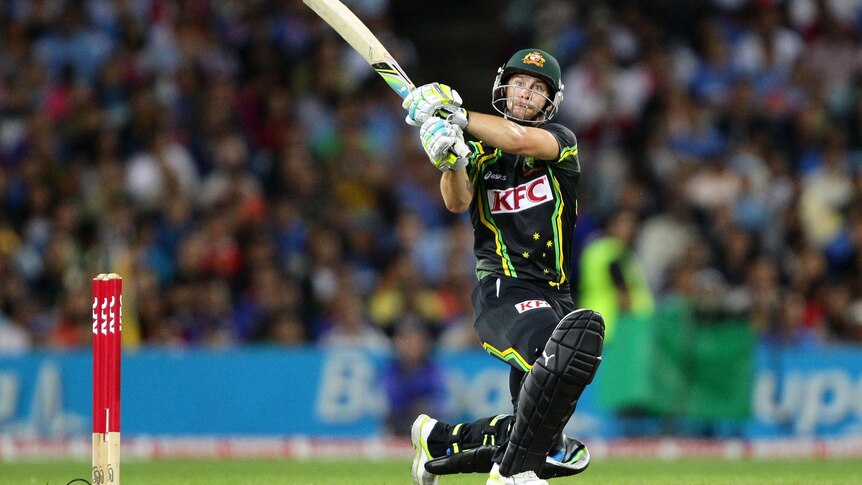 Matthew Wade smashes the ball during the International Twenty20 between Australia and India.