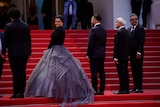 Taraneh Alidoosti  poses for photographers wearing a purple gown at the Cannes film festival.