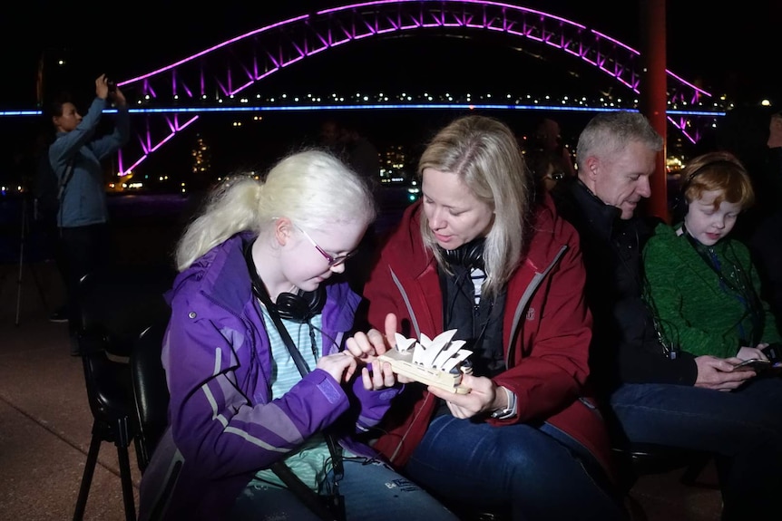 Zara Perry and her mother Rachel Perry hold a model of the Sydney Opera House.