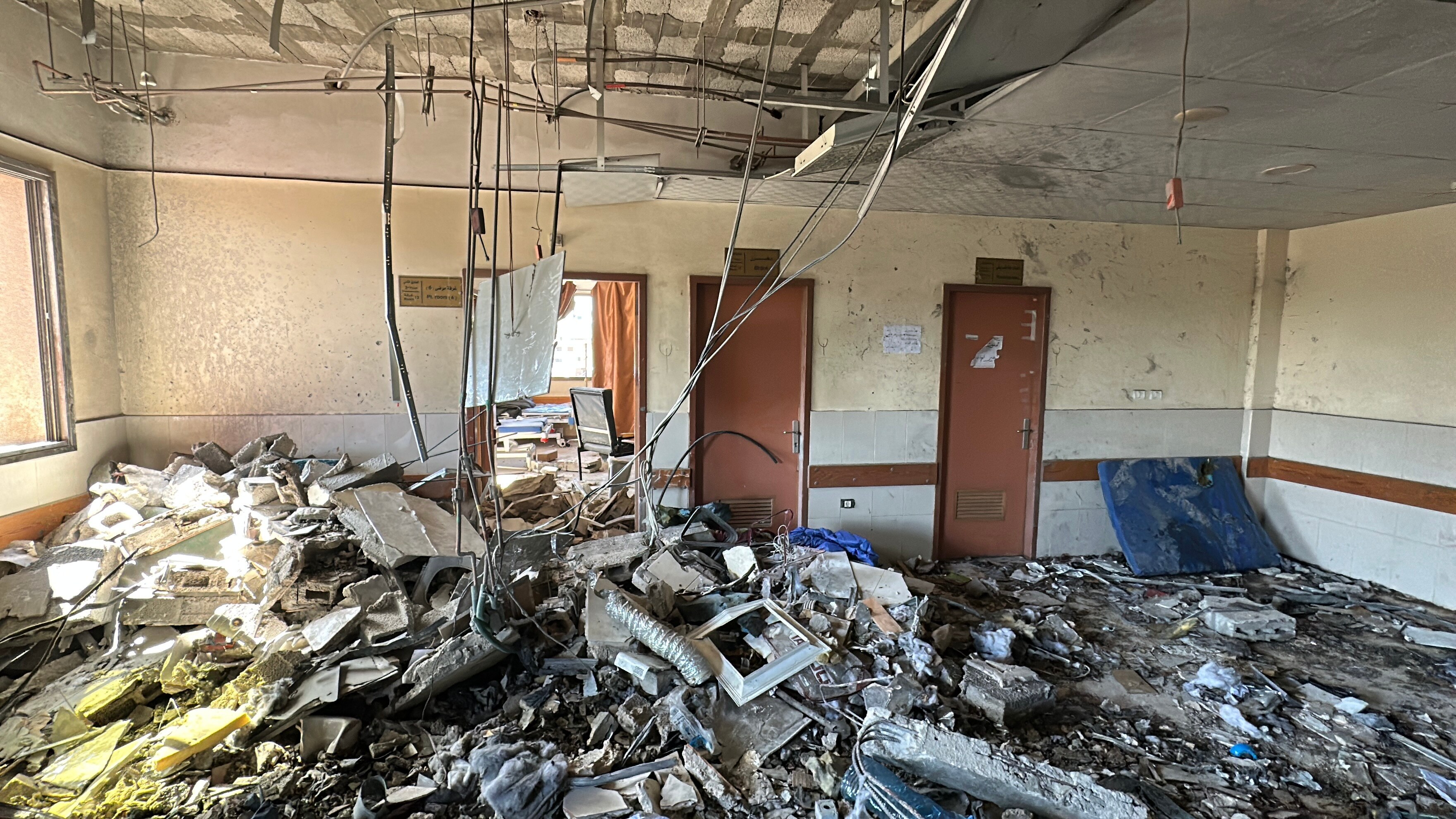 Rubble covers the floor of a large room
