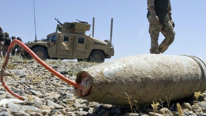 A soldier walks past an Improvised Explosive Device (IED)