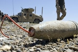 A soldier walks past an Improvised Explosive Device (IED)