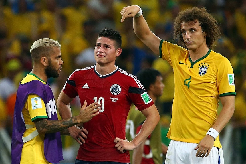 James Rodriguez is consoled by David Luiz and Dani Alves