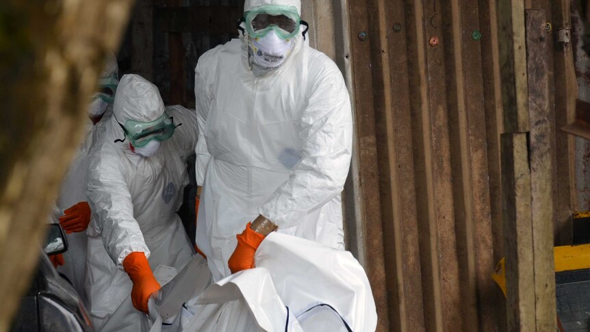 Red Cross workers in Monrovia carry body of Ebola victim