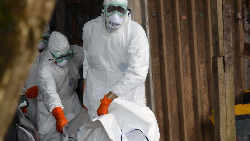 Red Cross workers in Monrovia carry body of Ebola victim