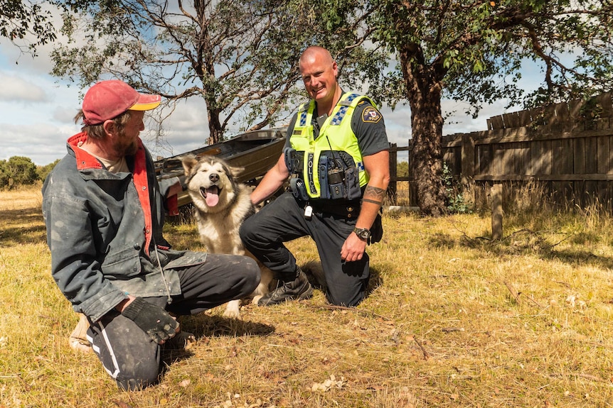 Dan Adams with his dog Koda and Randall, who rescued the dog during the fires.