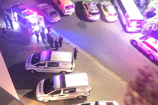 Police and vehicles outside a hotel in Cavill Avenue at Surfers Paradise.