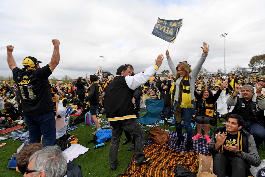 Fans jump and cheer at the Punt Road live screening