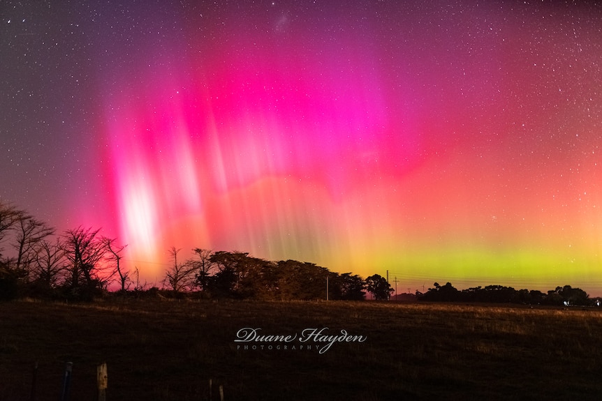 Aurora over country victorian landscape