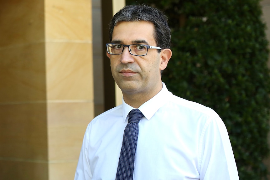 A mid-shot of Upper House Liberal MP Nick Goiran outside parliament in a white shirt and tie.