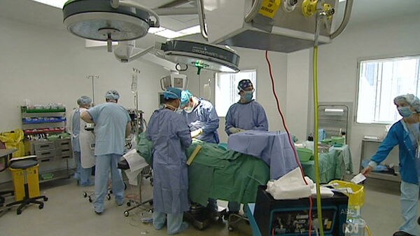 Doctors perform surgery in an operating theatre