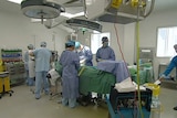 Doctors perform surgery in an operating theatre