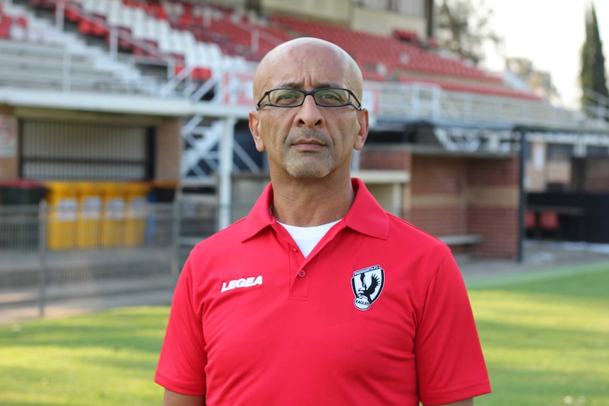 Portrait of older man on the field wearing a club uniform