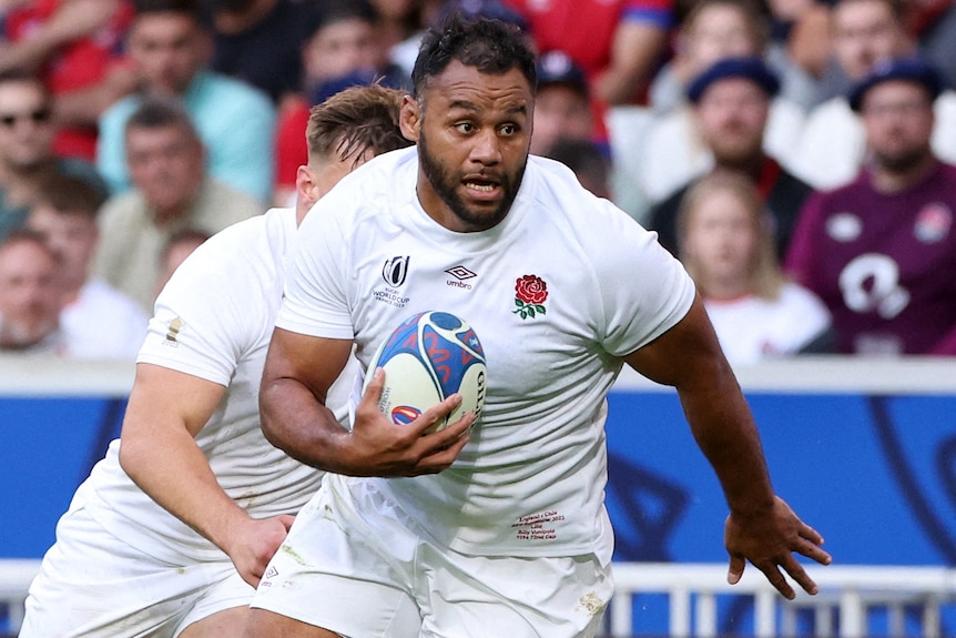 Rugby Union player Billy Vunipola, during a match for England, runs with the ball under his arm
