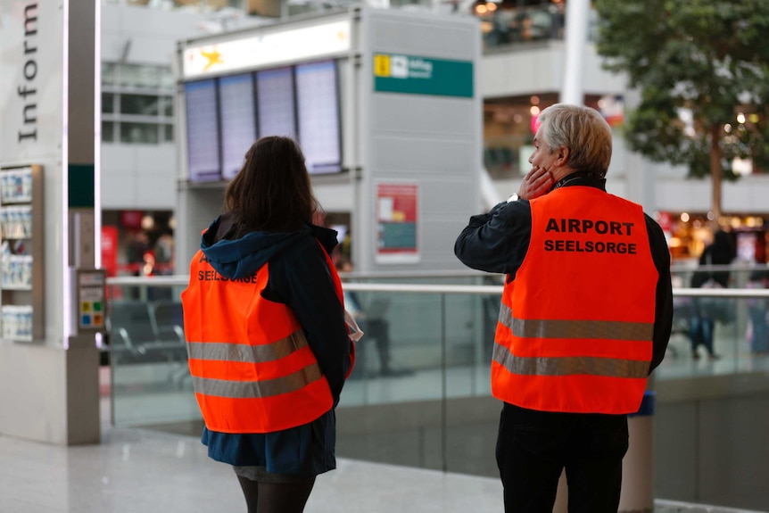 Pastoral staff wait at Dusseldorf airport