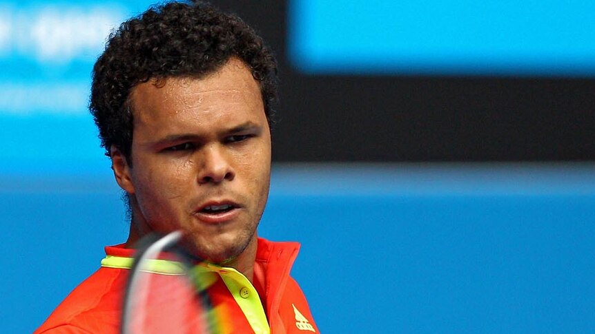 Jo-Wilfred Tsonga hits a forehand during his third round match against Frederico Gil at the Australian Open on January 21, 2012.
