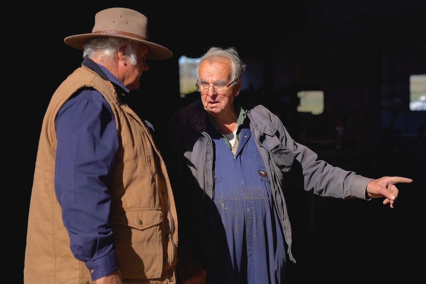 Farmer Graeme Gibson talks with mechanic Maurice Henry
