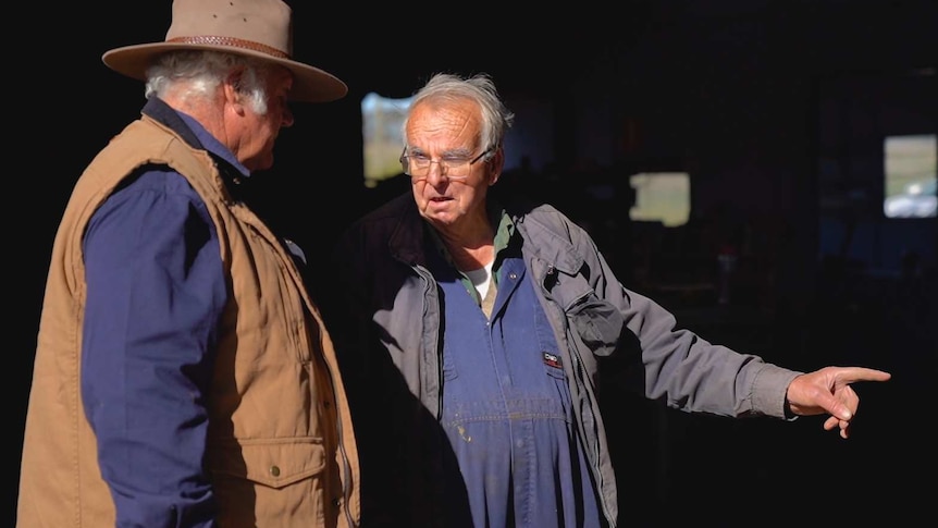 Farmer Graeme Gibson talks with mechanic Maurice Henry