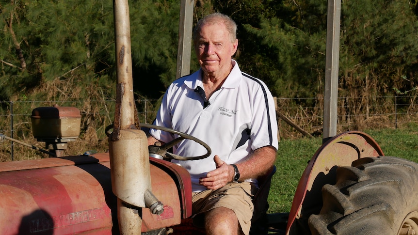 80 year old Bryan Watts sits on his tractor on his farm. 