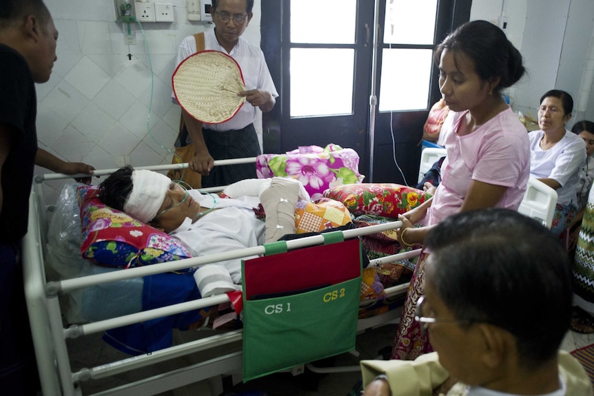 Injured Naing Ngan Linn lies on a hospital bed