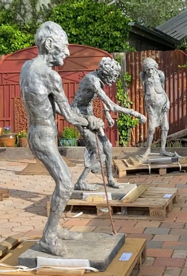 Three concrete statues modelled on older people