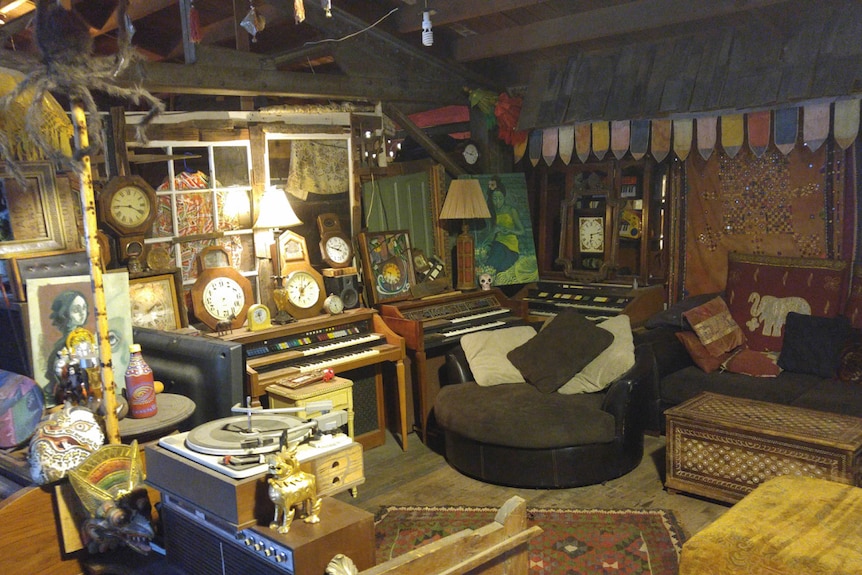 Dozens of vintage clocks, old pianos, and assorted artwork and eastern-style ornaments adorn the loft-like interior.