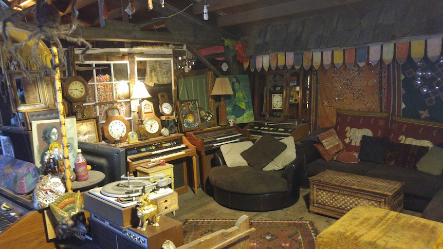 Dozens of vintage clocks, old pianos, and assorted artwork and eastern-style ornaments adorn the loft-like interior.