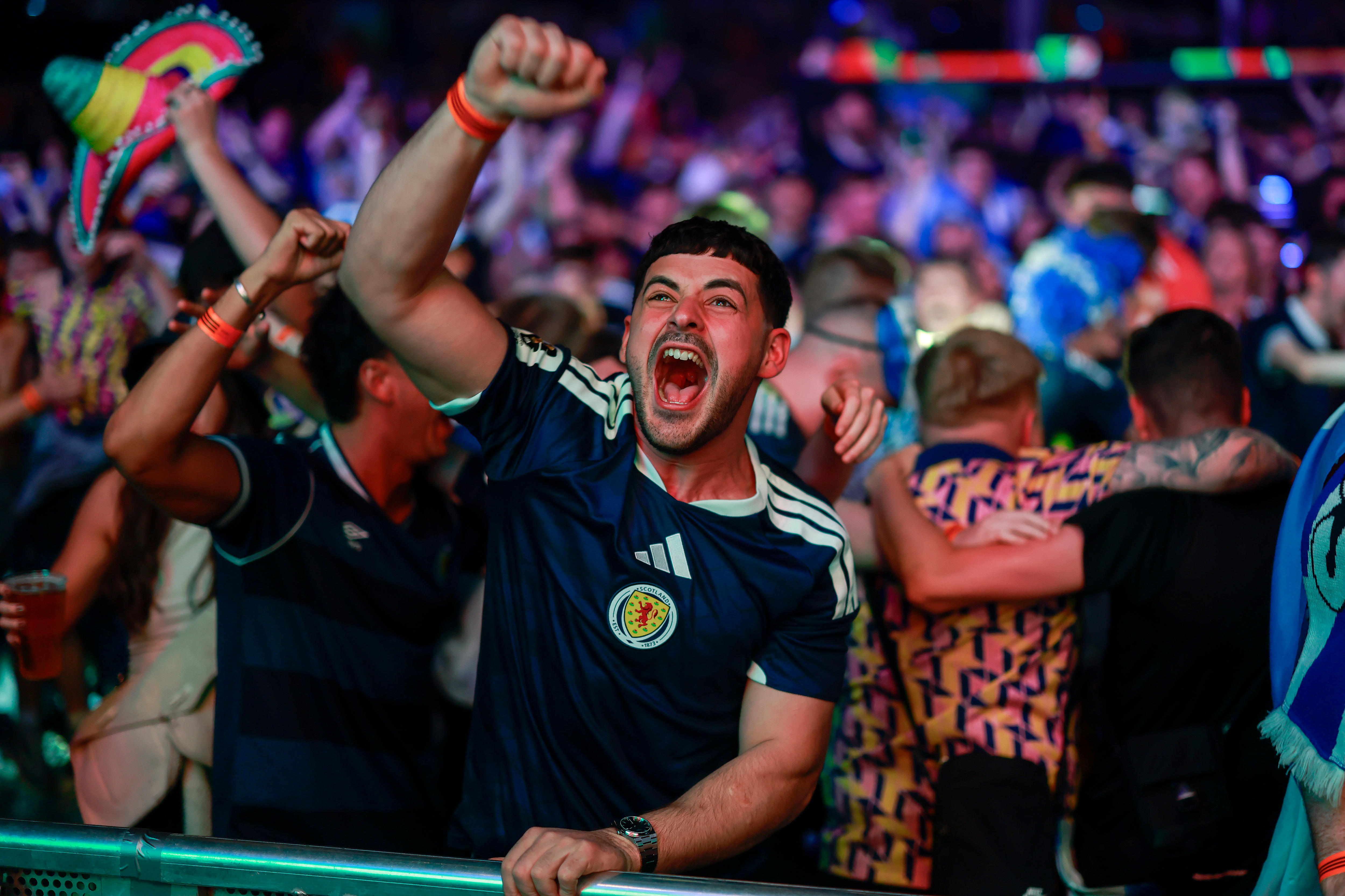 A Scotland fan celebrates a goal at a World Cup live site