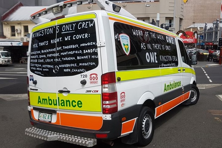 A Tasmanian ambulance with slogans written on its windows