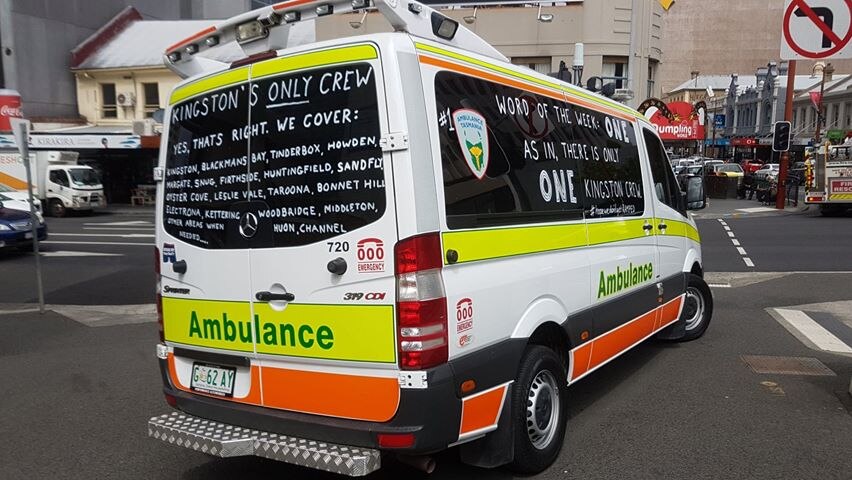 A Tasmanian ambulance with slogans written on its windows