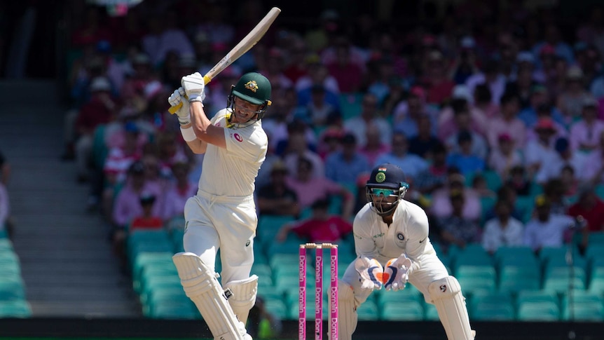 Australia batsman Marcus Harris has his bat above his head after slapping a shot during a Test against India at the SCG.