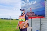 A South Australian police officer stands at a coronavirus checkpoint.