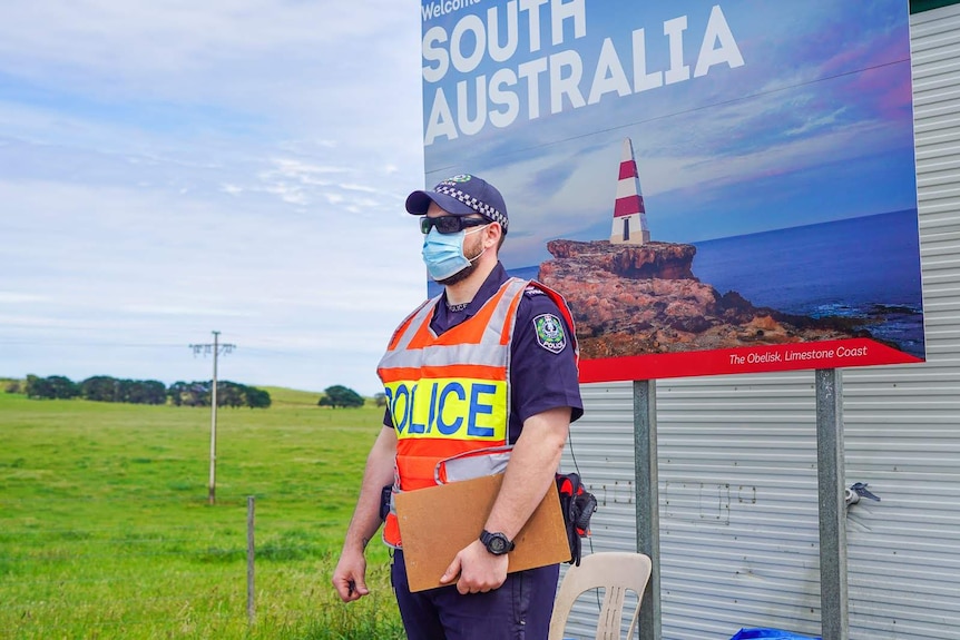 A South Australian police officer stands at a coronavirus checkpoint.