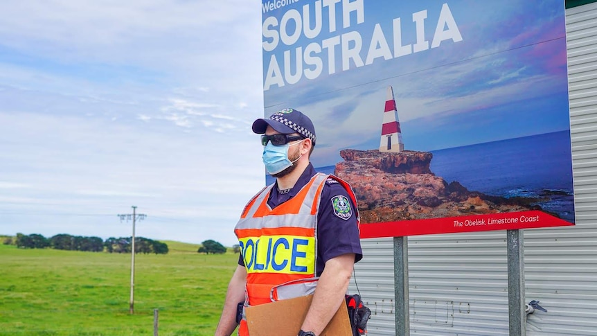 A South Australian police officer stands at a coronavirus checkpoint.