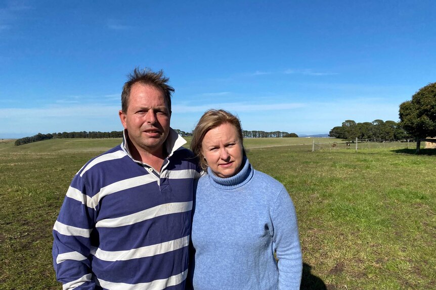 A man and woman stand in a paddock in western Victoria