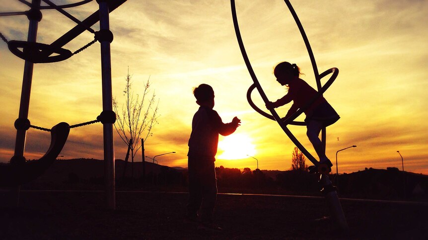 Children playing on playground equipment in Canberra at sunset. *Good Generic. May 2014.