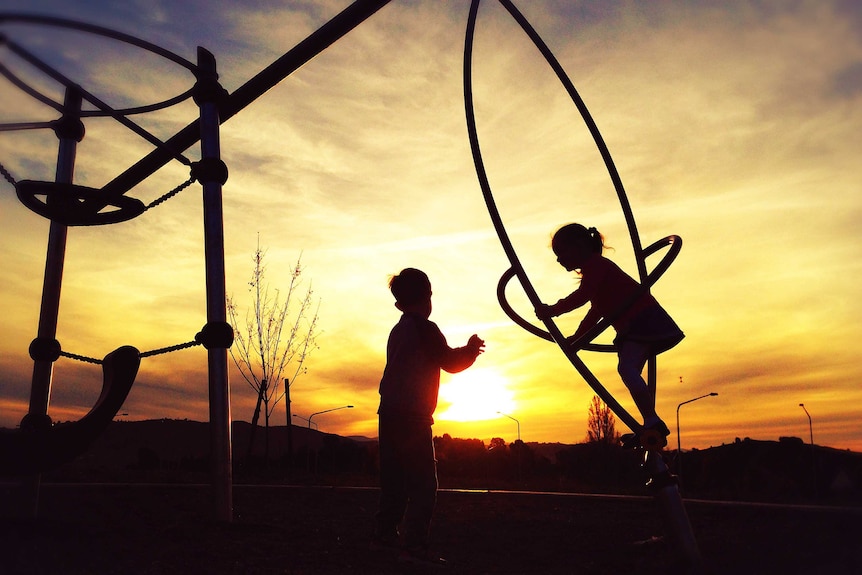 Children playing on playground equipment