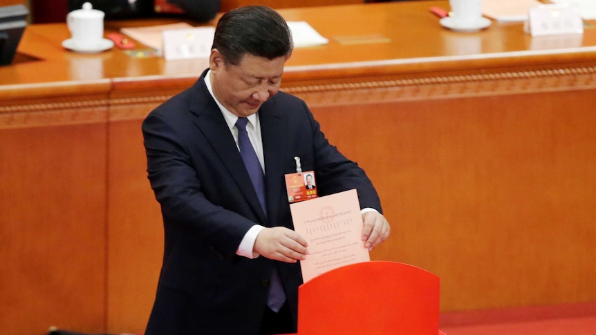 Chinese President Xi Jinping drops his ballot during a vote on a constitutional amendment lifting presidential term limits.