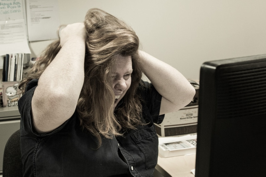 A woman yells at the computer