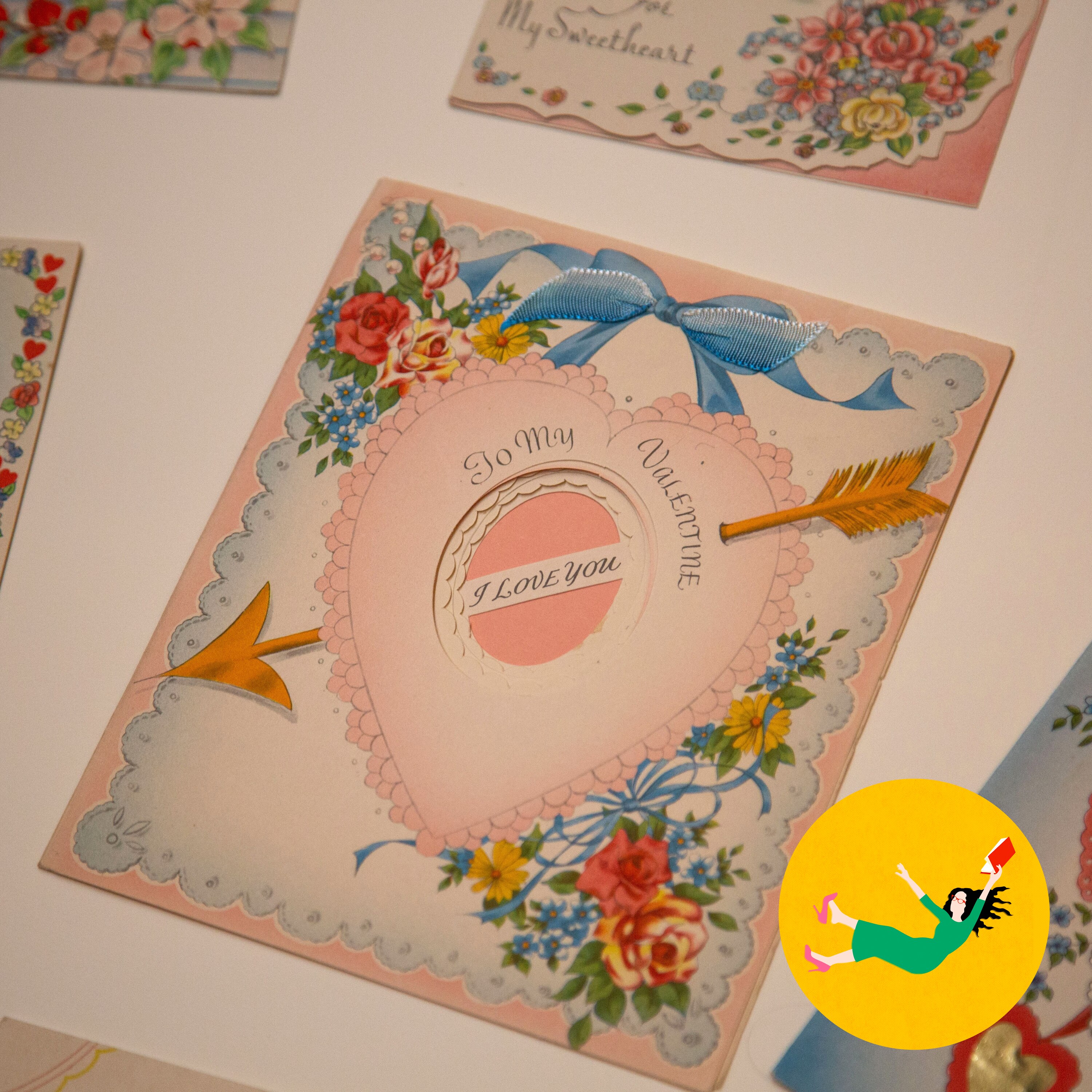 A vintage Valentine's card features a pink heart, floral border, Cupid's arrow, and 'To My Valentine'.