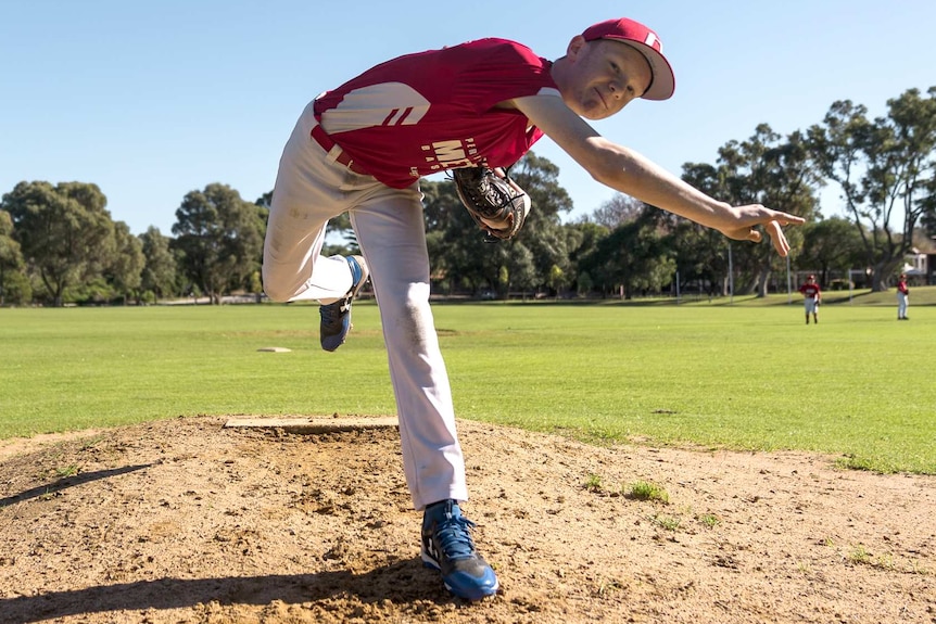 Little league player Ty Spaulding throws a baseball.