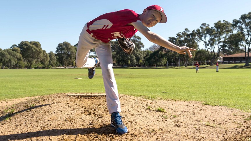 Little league player Ty Spaulding throws a baseball.