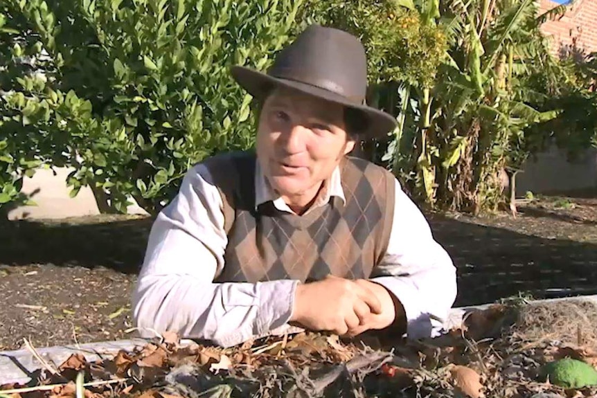 Tino Carnevale kneeling at garden bed resting his hands on pot illustrating our Gardening Australia episode recap.