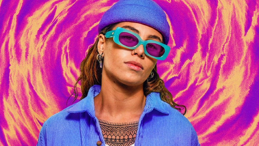 Tash Sultana in purple beanie and shirt, blue glasses, against purple and yellow background