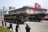 Two missiles painted in camouflage are paraded across Kim Il Sung Square during Saturday's military parade on Pyongyang.