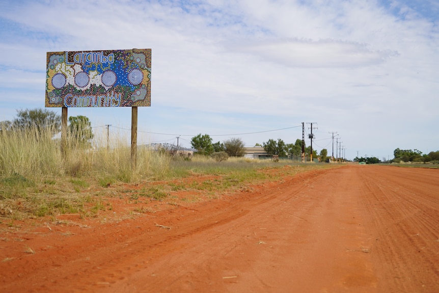 A sign near a red dirt road